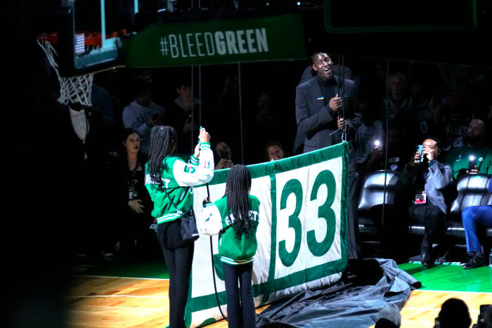 Former Boston Celtic and Basketball Hall of Famer, Kevin Garnett along with his daughters help raise his number 5 to the rafters along with the other retired players numbers after the game between the Boston Celtics and Dallas Mavericks at TD Garden.